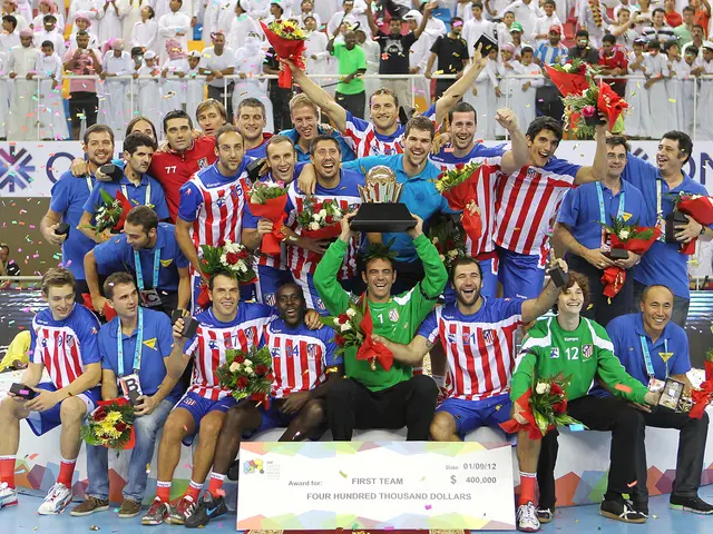 In this image, we can see people wearing sports dress and one of them is holding an award and some...